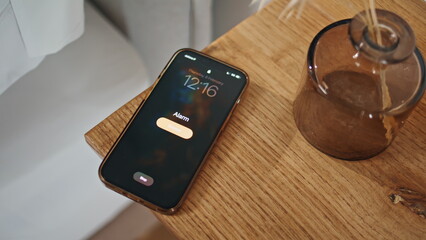 Hand turning smartphone alarm clock off closeup. Digital device indicating wake