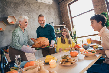 Portrait of big friendly family serving grilled tasty turkey celebrate thanksgiving day dinner flat indoors