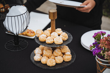 A person is carefully holding a beautifully arranged plate of delicious food on a table, ready for a lovely meal gathering filled with laughter and joy with friends or family