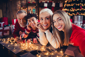 Photo of excited family having fun in christmas eve time night lying floor in house indoors