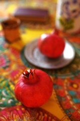 Culinary still life with pomegranates on a beautiful table