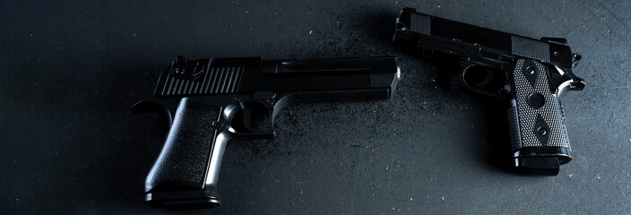 Two guns on black table, criminal concept