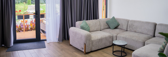 Gray sofa in hotel corridor, comfort concept