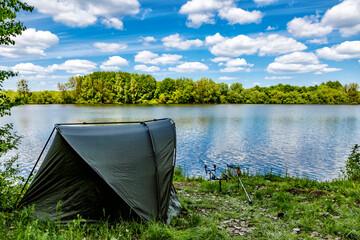 Carpfishing session at the Lake.Carp Angling scenic landscape overlooking lake at and blue sky with...