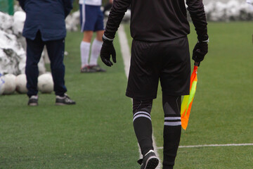 pla The side judge with the flag goes on the field.yer kicking ball