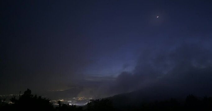 View of Gotemba city and the crescent moon from the foggy Hakone mountains in Japan. 4K,H.264,422,10bit.