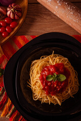 Sao Paulo, SP, Brazil - August 16 2022: Close up of spaghetti with tomato sauce on black background, top view details.