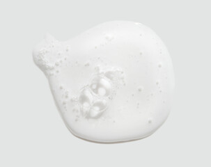 Close-up of white liquid texture with bubbles in minimalist design concept.