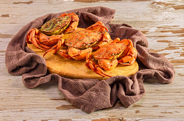 Cooked crabs on wooden board