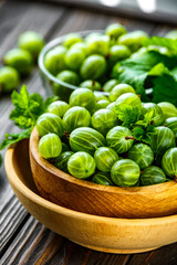Green Organic Berries Gooseberries.Green gooseberries in a wooden bowl.Gooseberries on the wooden table. Harvest concept. Vegetarian food.
