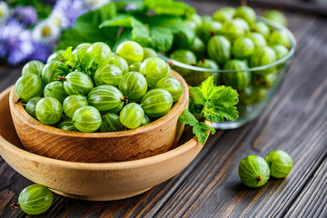 Green Organic Berries Gooseberries.Green gooseberries in a wooden bowl.Gooseberries on the wooden table. Harvest concept. Vegetarian food.