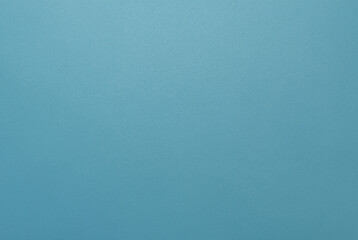 Simple minimalist blue textured background with a smooth surface, perfect for design projects.
