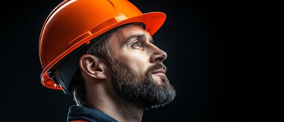 A focused construction worker with an orange safety helmet, representing dedication and professionalism in the industry.