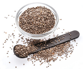 Heap of chia seeds in glass bowl and spoon on white background. Top view.