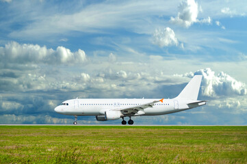 Airplane riding on the runway before or after flight. White commercial airplane at the airfield, travel background with modern airplane with blank livery