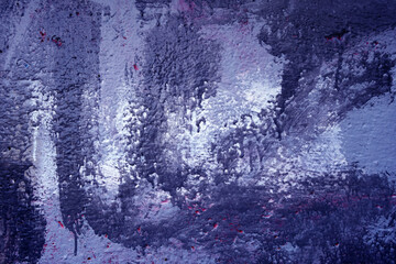 Blue paint brush strokes on cement building wall.