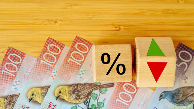 Wooden blocks with bank interest rate percent of bank with New Zealand dollar, Financial analysis, crisis project or economic growth concept. New Zealand money, close up, Flat lay background - Powered by Adobe