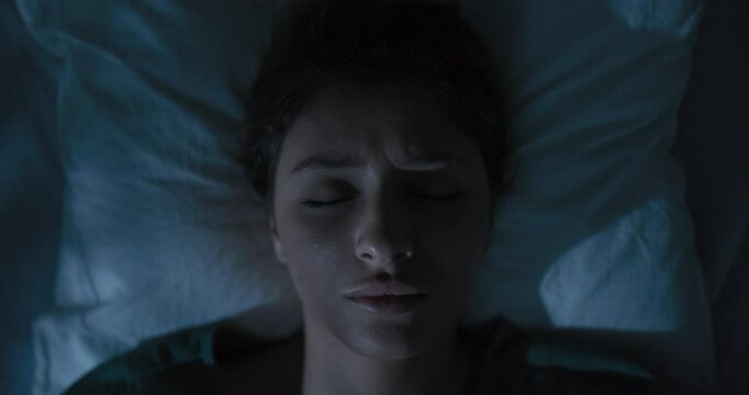 Exhausted woman wakes up in hospital ward.