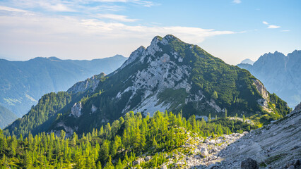 The Julian Alps reveal stunning landscapes, showcasing rugged peaks and lush greenery under a...