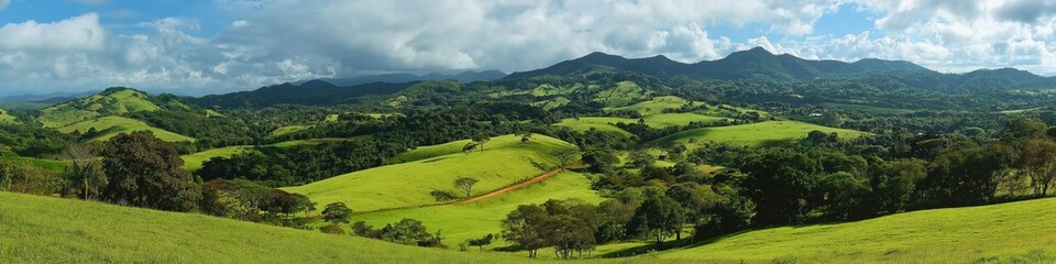 Obraz premium A beautiful landscape with a green hillside and a clear blue sky. The sky is dotted with clouds, giving the scene a peaceful and serene atmosphere