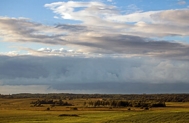 Obraz premium Dramatic sky over the fields. Agricultural landscape in eastern Lithuania.