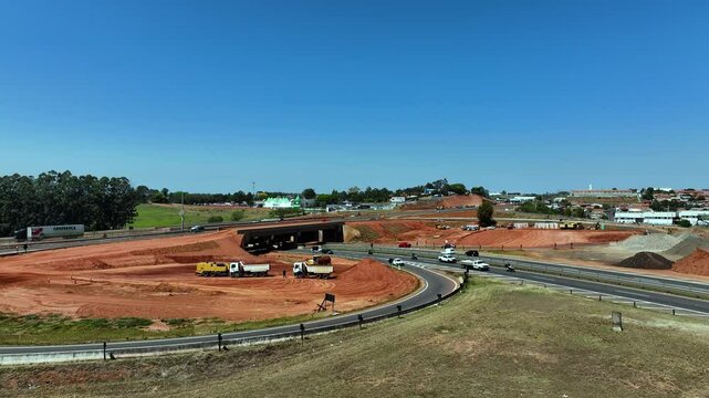 High-angle aerial view of highway infrastructure development. Construction of the access road to Shopping Botucatu, on the Teacher Joao Hipolito Martins Highway (SP-209). 10/05/2024 