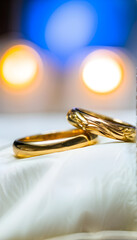 Fototapeta premium Golden wedding rings on pillow Marriage Engagement Gem Jewelry Bridal Groom Accessory Love Romance