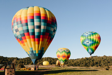 Hot air balloons and fields or hills