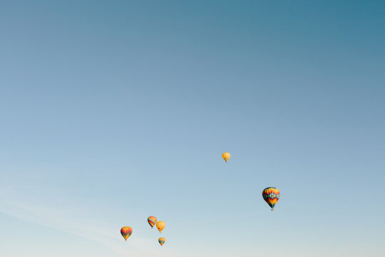 Hot air balloons in an empty blue sky