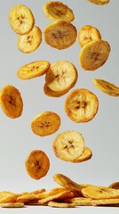 Banana chips, crispy, falling on a plain white background