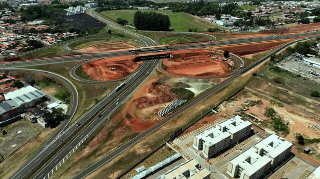 High-angle aerial view of highway infrastructure development. Construction of the access road to Shopping Botucatu, on the Teacher Joao Hipolito Martins Highway (SP-209). 10/05/2024 