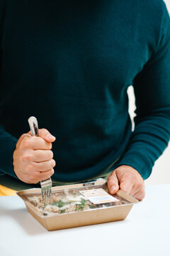 Male hands rip opening the meal box