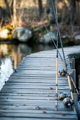 Fishing dock with poles near calm water, suitable for outdoor recreation or lake scenes