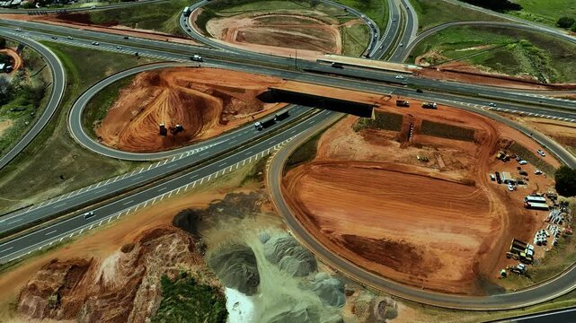 High-angle aerial view of highway infrastructure development. Construction of the access road to Shopping Botucatu, on the Teacher Joao Hipolito Martins Highway (SP-209). 10/05/2024 