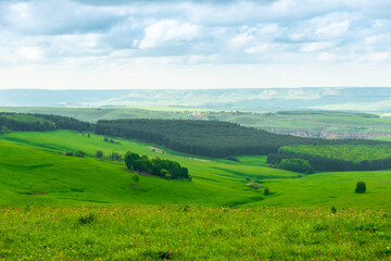 A picturesque landscape with green hills and forest in the foothills of Elbrus. Russia