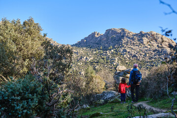 Fototapeta premium A Mother and son treking together admiring mountain scenery.
