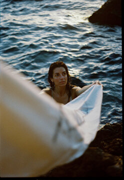 Woman Holding Fabric By Sea