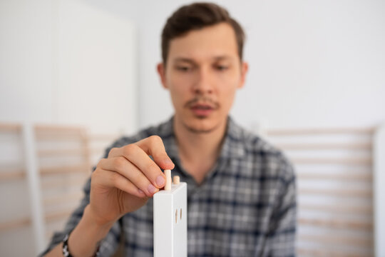 Candid man fastening dowel pin