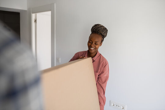 Excited woman holding big box