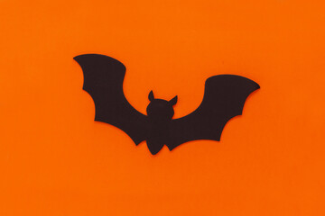 Bat on orange background. Silhouette halloween