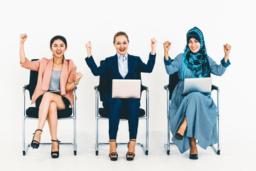Obraz premium Happy young businesswomen group celebrating work success together. Workplace community and human resources concept. uds