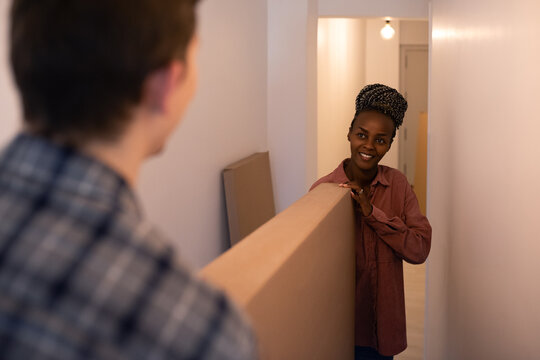 Diverse couple moving in