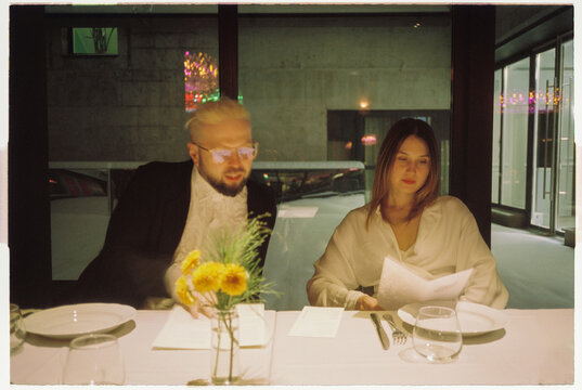 Elegant couple reading menu in gourmet bistro night out