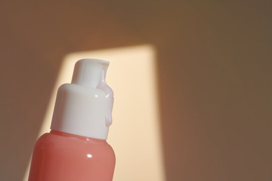 An unlabeled pump bottle of lotion, a streak of dense-textured cream 