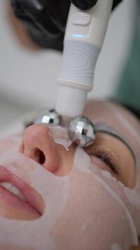 Close-up of facial treatment with beauty device. Concept of synergistic skin care