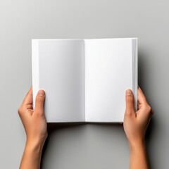 An open blank book held by two hands, inviting creativity and thoughts with its empty pages.