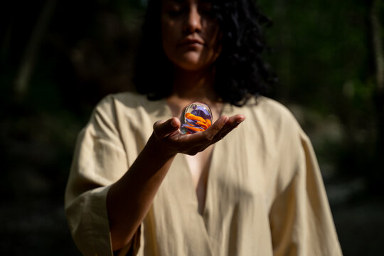 Woman Holding Colourful Glazed Sphere 