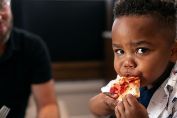 Child Enjoying a Slice of Pizza