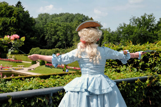An opera singer performs on stage to a crowd in a well-kept castle park in Arcen, Netherlands