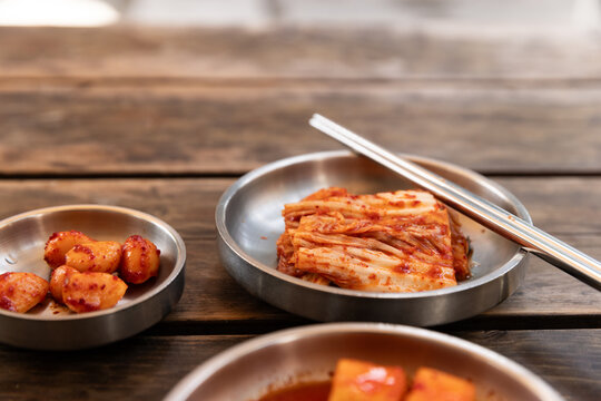 Closeup of picked vegetables served on metal plates at a restaurant in Seoul, Korea. 